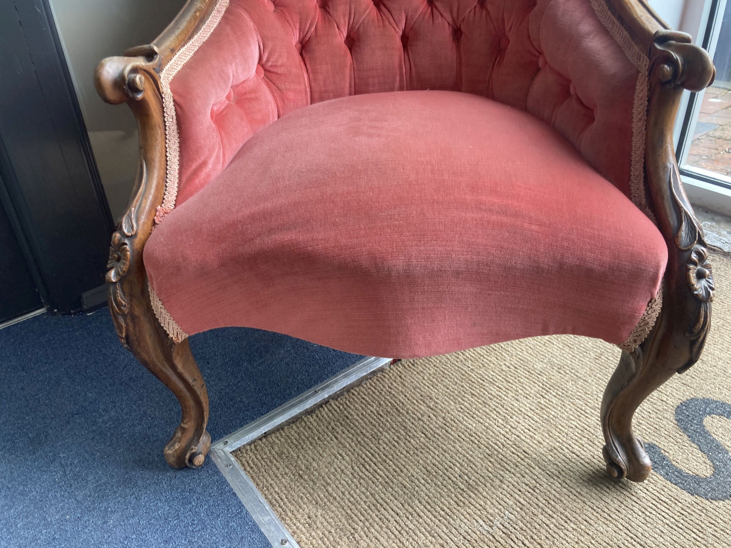 A Victorian walnut framed buttoned spoon back upholstered armchair, width 65cm, height 91cm